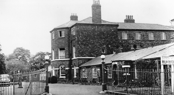 Winslow Hospital seen through the gate from the High Street